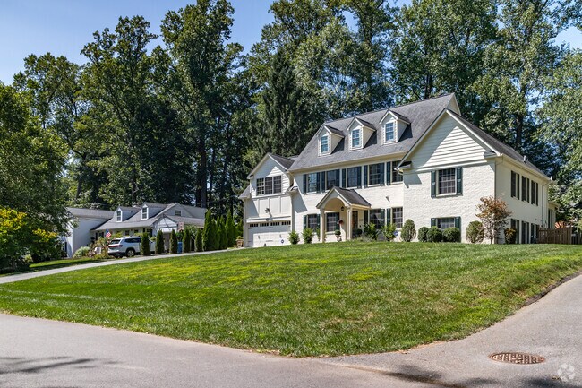 A row of massive single family homes nestled on a hill in Manor Park.