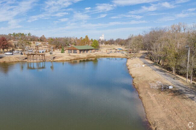 Harrah Heritage Park has a lake that the walking trail around it along with a small amphitheater