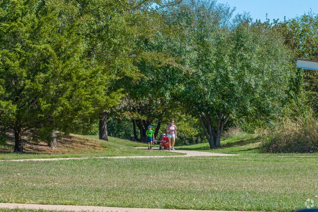 Families enjoy exploring the tree lined trails in Highland Oaks.