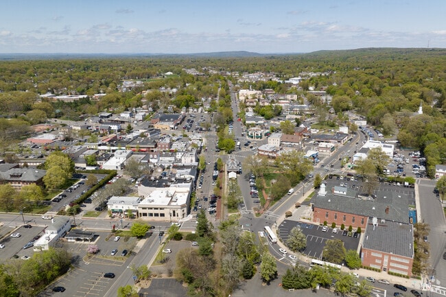 An aerial view of downtown Tenafly, NJ showing retail and residential properties.