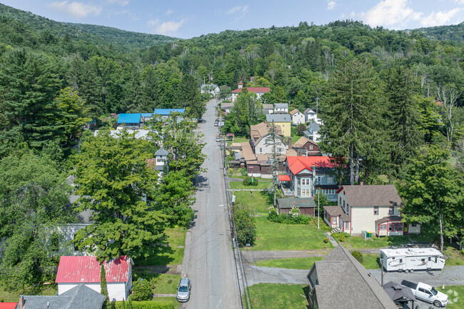 Pine Hill stretches on its Main St surrounded by pines and mountains.