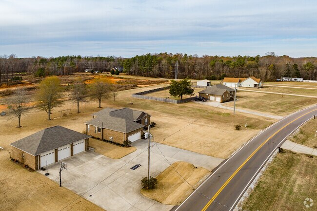 A row of larger homes with detached 3 car gages in kElmont.