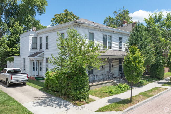 Italianate homes of Historic Jefferson have decorative roof brackets and trees for privacy.