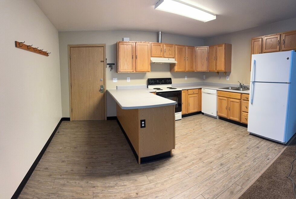 Bright and open kitchen featuring wraparound countertops, full-size appliances