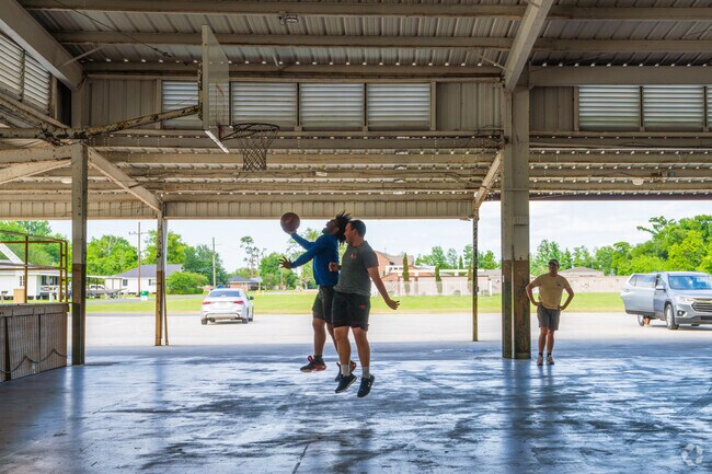 Athletes from Galliano enjoy playing basketball outside in the shade at the Cut Off Youth Center.
