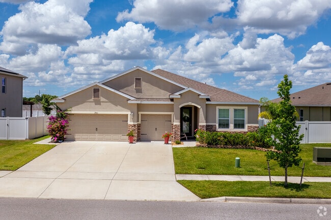 This Neo City single-family home features beautiful brick accents and colorful landscaping.