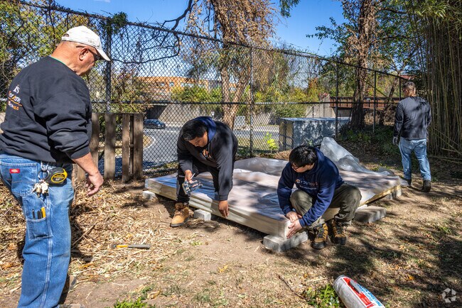Students and educators from Isles Youth Institute construct a new shed at Roberto Clemente Park.