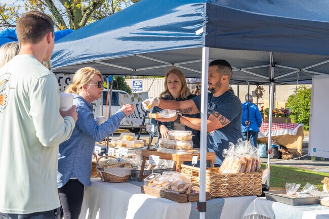 Vendors at the Marietta Square Farmers Market offer patrons samples of their products.