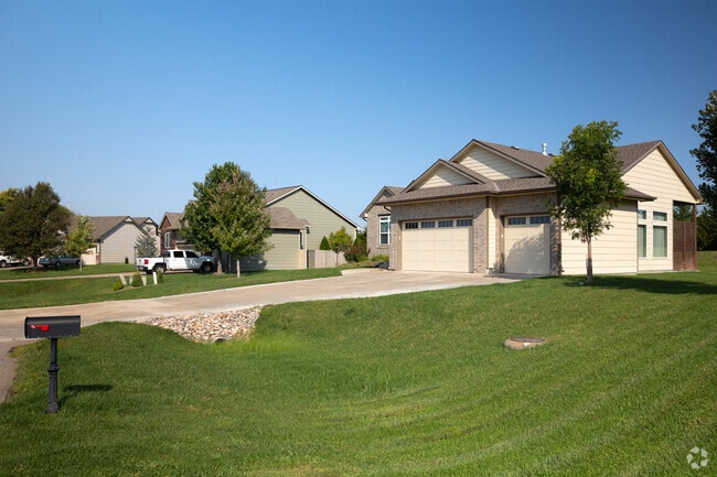 Ranch-style homes line a quiet Rose Hill street, popular for spacious yards and mature trees.