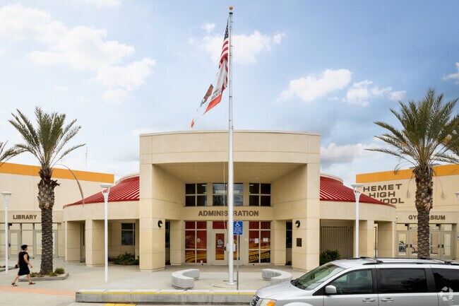 Tall palm trees welcome students at the entry of Hemet High School.
