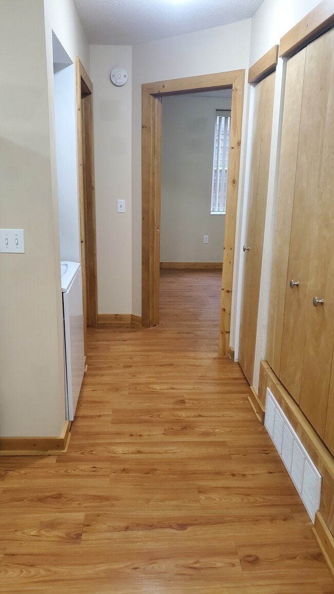 Hallway with stacked washer/dryer and closet
