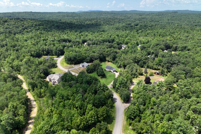 Forested landscape surrounds homes in the quiet Acton, Maine.