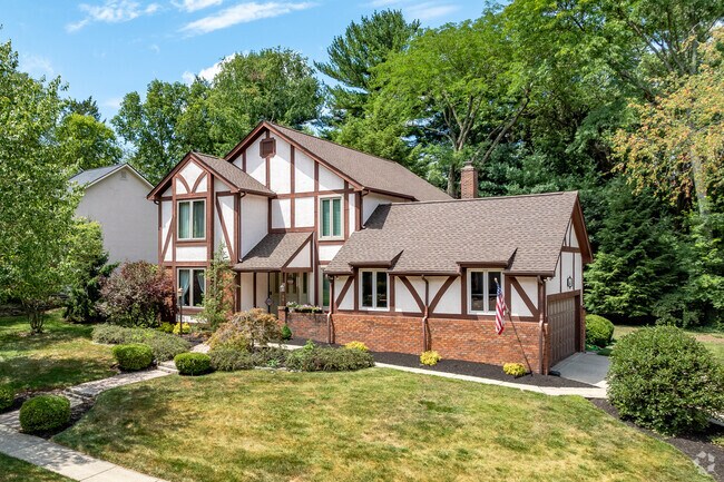 A Tudor style home in Olentangy Highlands features a side load two-car garage.