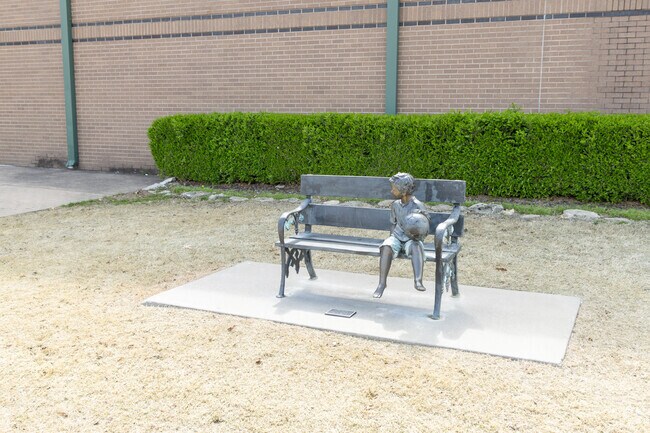 The sculpture of a kid with a soccer ball sits outside the Owasso 6th Grade Center.