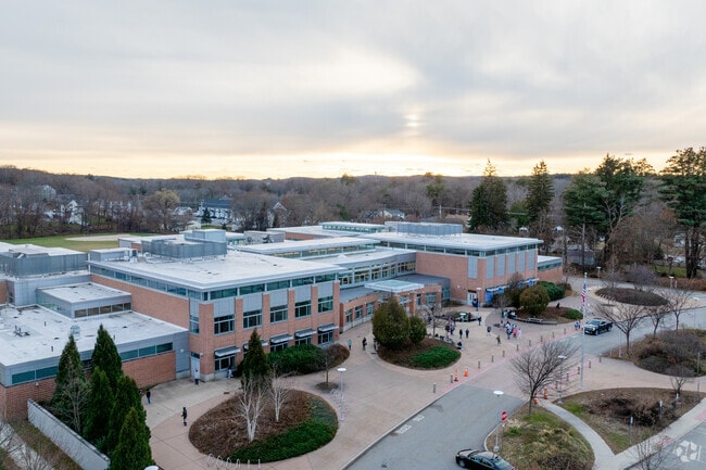 David J. Quinn Middle School has a large front patio with trees and shrubs.