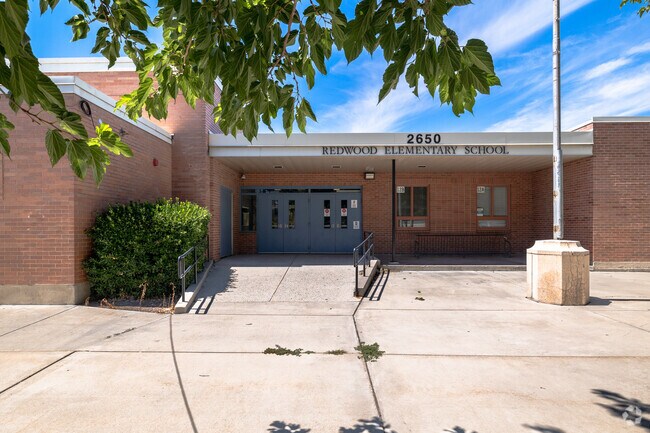 Blue doors stand out against red brick at the entrance of Redwood Elementary School.