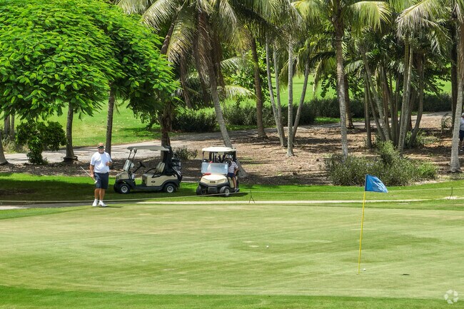 Golfers enjoying the afternoon at the Village Golf Course in La Mancha neighborhood.