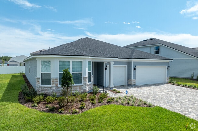 This new one story has lots of garage space and a large driveway.