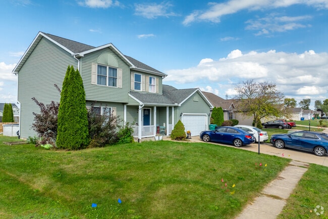 This two-story home in Westville includes a garage and sidewalks for easy neighborhood strolls.