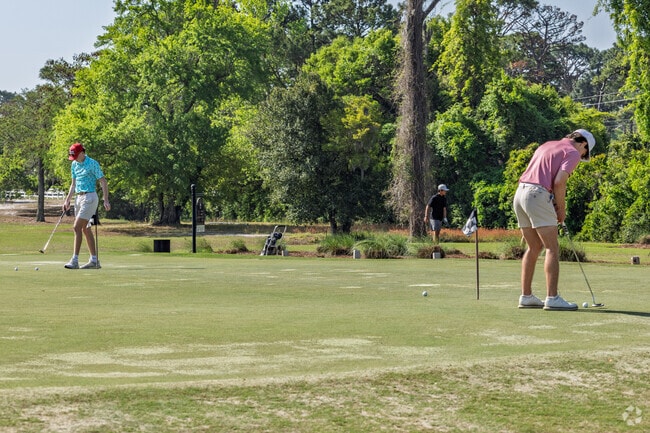 Friends from Rogersville-Bradley Creek practice their putting skills at the Wilmington Golf Course.