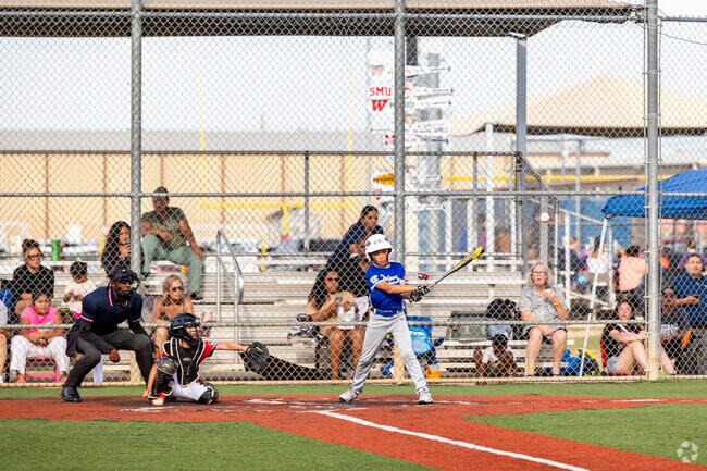 Klein Crossing residents enjoy baseball and gather to watch their kids play in little league.