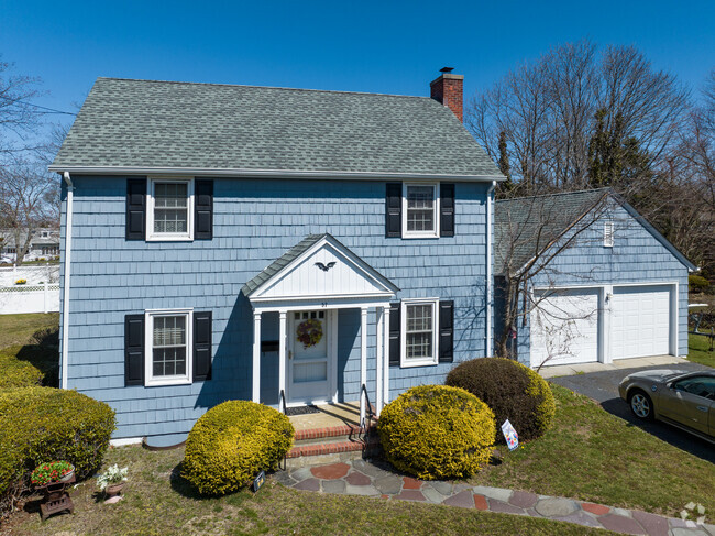 A simple and quaint center hall Colonial is typical of Islip.
