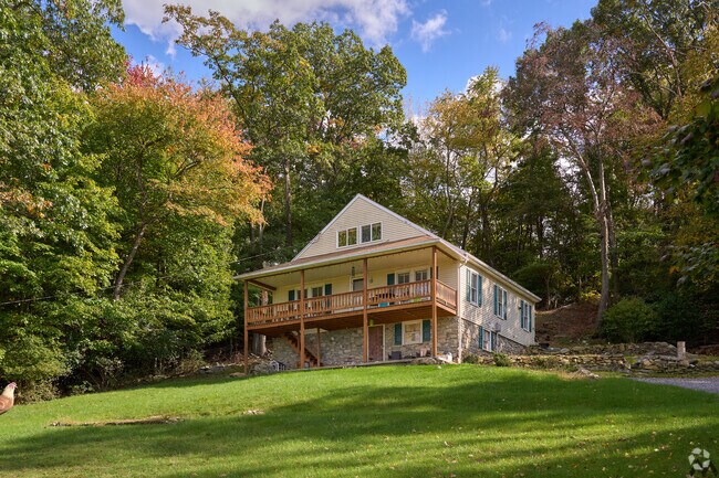 A large home with a deck overlooks the valley from atop the mountains in Highfield-Cascade.