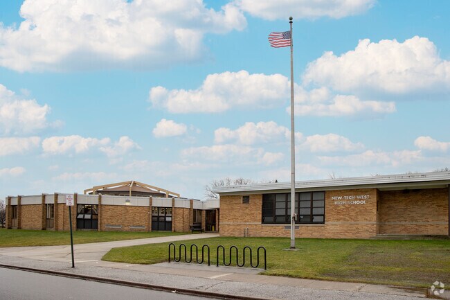 A street view of the charming brick exterior of New Tech West.