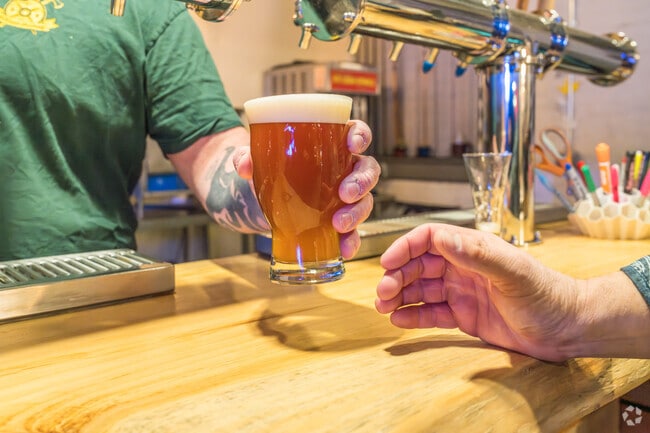 Drink beer and socialize in Meduseld Axe Throwing and Bar nearby Stadium Distrct.