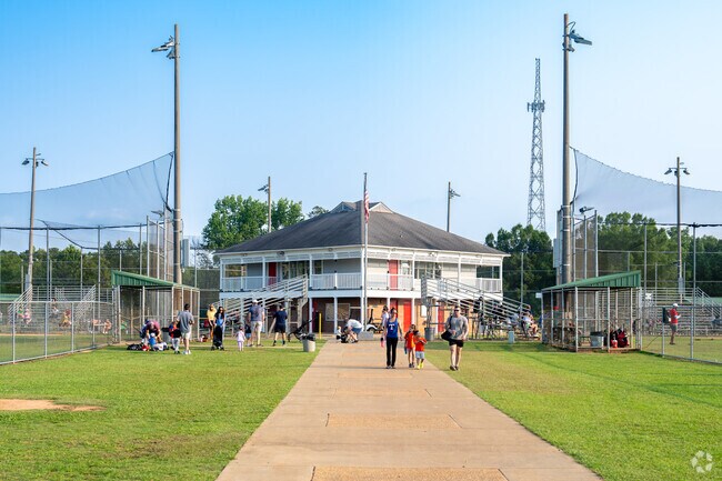 Boys and girls swing for the fence as their parents cheer them on at West Ridge Park near Stephens Woods.