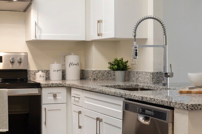 Renovated Package II kitchen with white cabinetry, quartz countertops, stainless steel appliances, and hard surface flooring