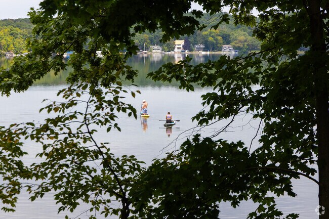 Residents paddle board at Beaver Lake in Chenequa.