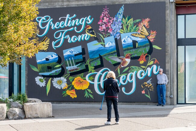 Residents of Southwest Bend taking a picture next to the newest mural in the neighborhood.