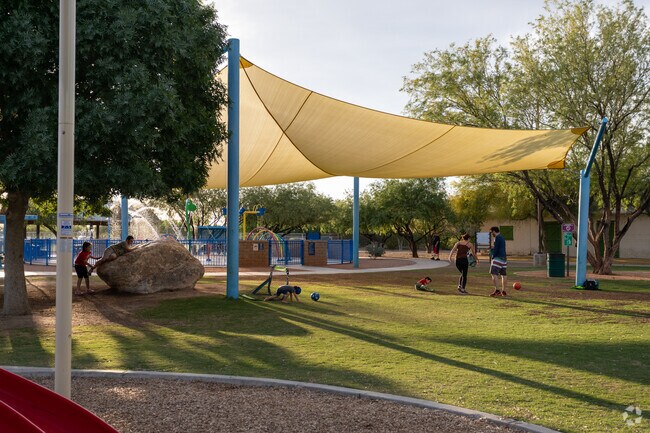 A family enjoys an afternoon playing at Brandi Fenton Park located near Cabrini.