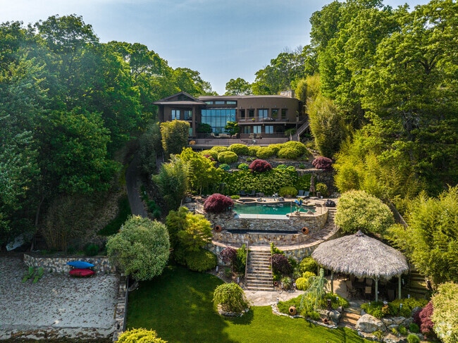 This hillside custom home in Hopatcong includes a scenic pool and panoramic lake views.
