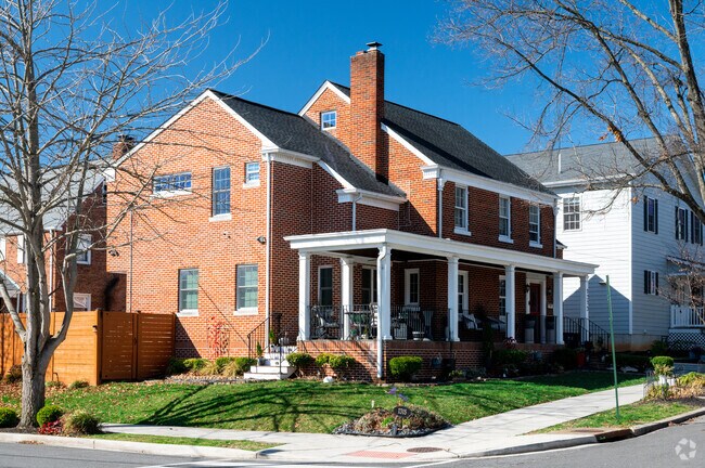 An ornate Federal-style house with a large porch