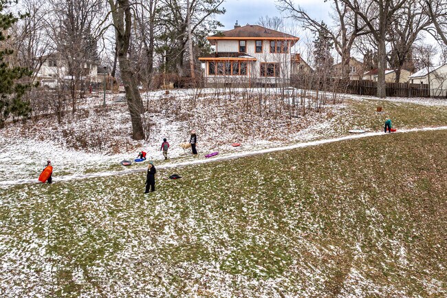 Children enjoy sledding on the hill at Audubon Park.