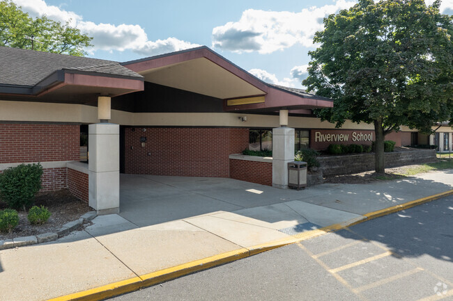 Riverview Elementary School's entrance has a shaded entryway for students to wait at.