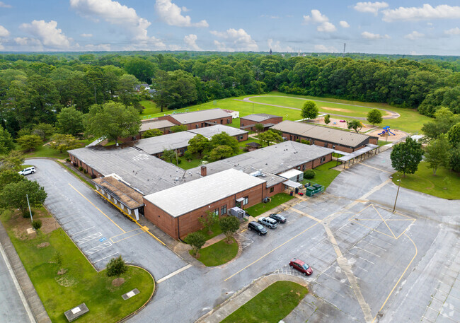 Elm Street Elementary School has a large campus with green landscapes.