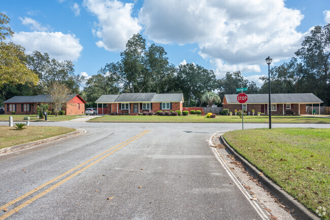 A row of brick ranch homes lines a street in Putney.