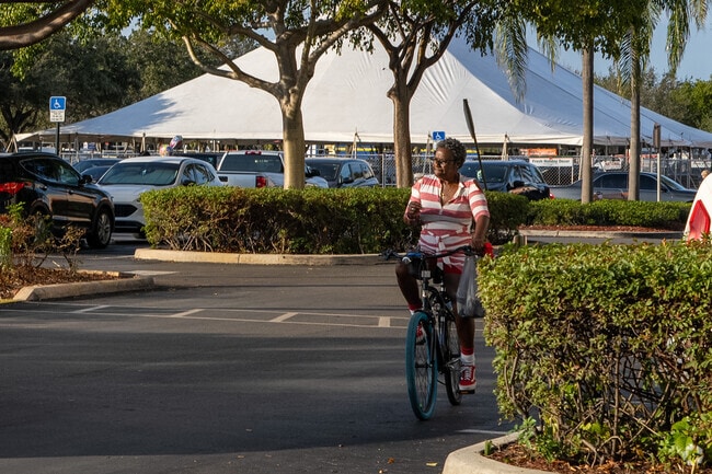 Lady Bike riding in front of the mall in Welwyn ManorA woman rides her bike past the mall in Welwyn Manor.