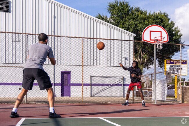 Play basketball on the courts at Waggaman Playground with friends.