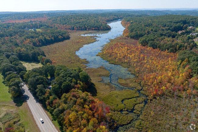 Fall foliage lines the edge of Eames Pond along Route 122 in Paxton.