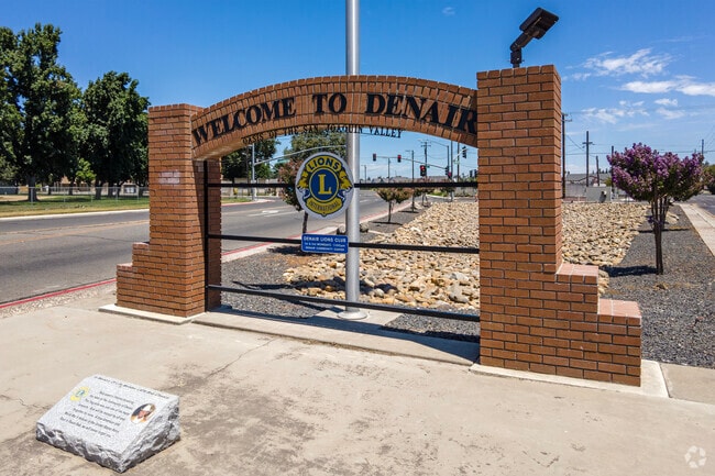 A brick sign welcomes visitors to the small city of Denair California.