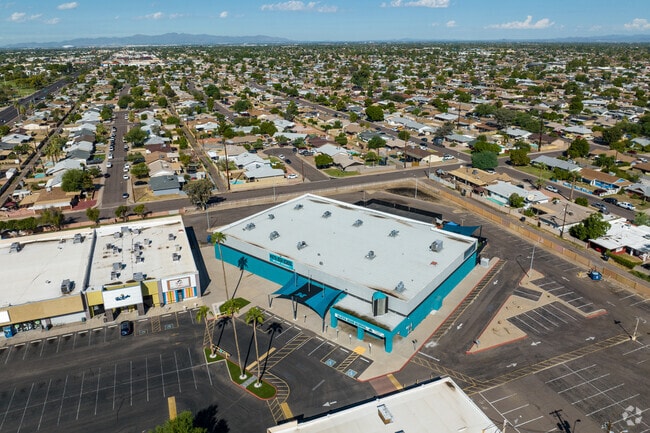 The parking lot at Maya High School is located next to the building.