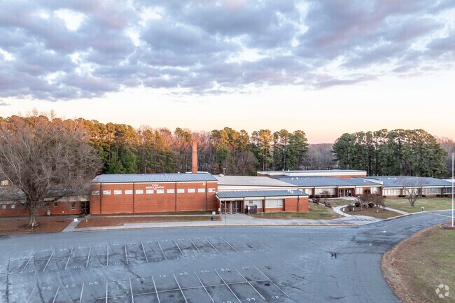Tall mature trees surround Tyro Middle School.