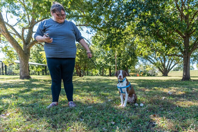 A puppy and its owner enjoy Hope Martin Memorial Park together.