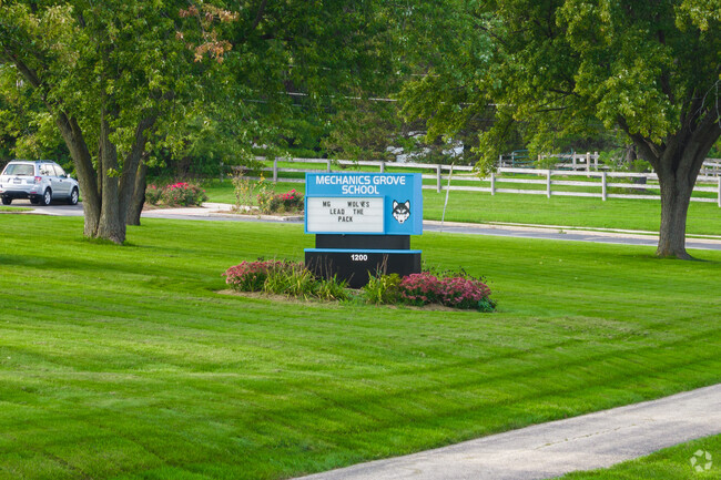 The blue school pylon signals the entrance of Mechanics Grove School