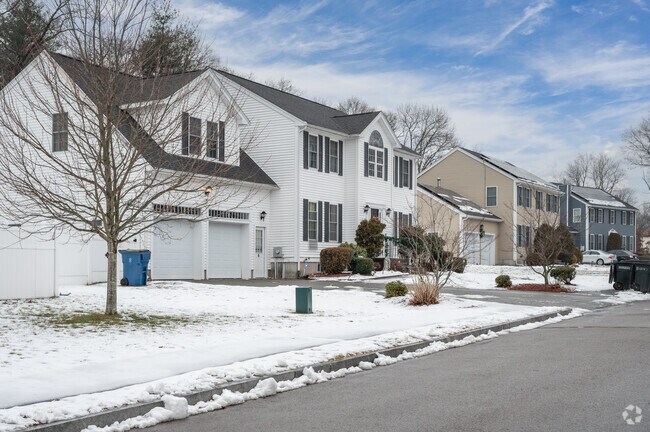 A row of sprawling colonial revival homes line a  street in Randolph.