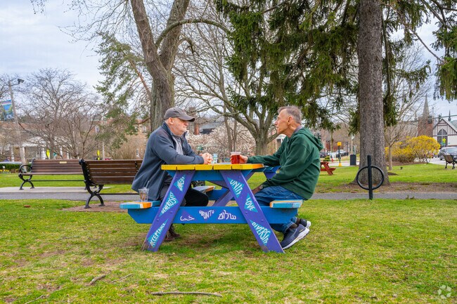 Enjoy coffee and a chat with a friend at the Newton Center green space.